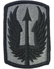 Military patch with a central emblem on a gray background