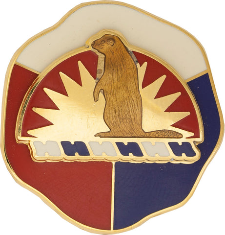 gold metal pin with a brown bear in the middle and white, red and blue on the background