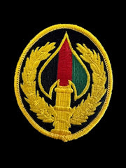 Embroidered patch with a circular design on a blue textured background