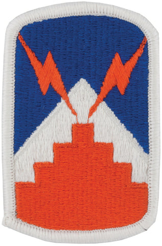 An embroidered patch featuring a blue and orange design with a white border, representing the 7th Signal Brigade unit insignia.