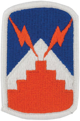 An embroidered patch featuring a blue and orange design with a white border, representing the 7th Signal Brigade unit insignia.