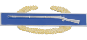 Decorative badge with a blue background and gold laurel wreath featuring a rifle.