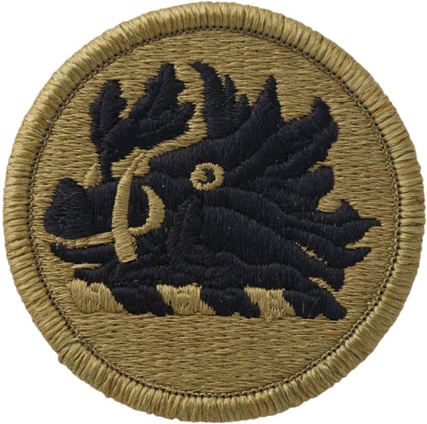 Circular patch with black embroidered design on a green background
