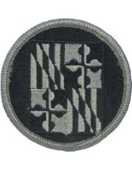 Circular patch with a black and gray design on a white background