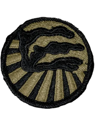 Round embroidered patch with green background and emblem in black